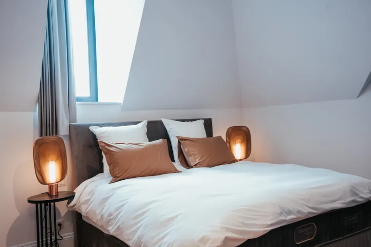 Chambre Tradition — lit douillet sous la lucarne, sous un haut plafond cathédrale